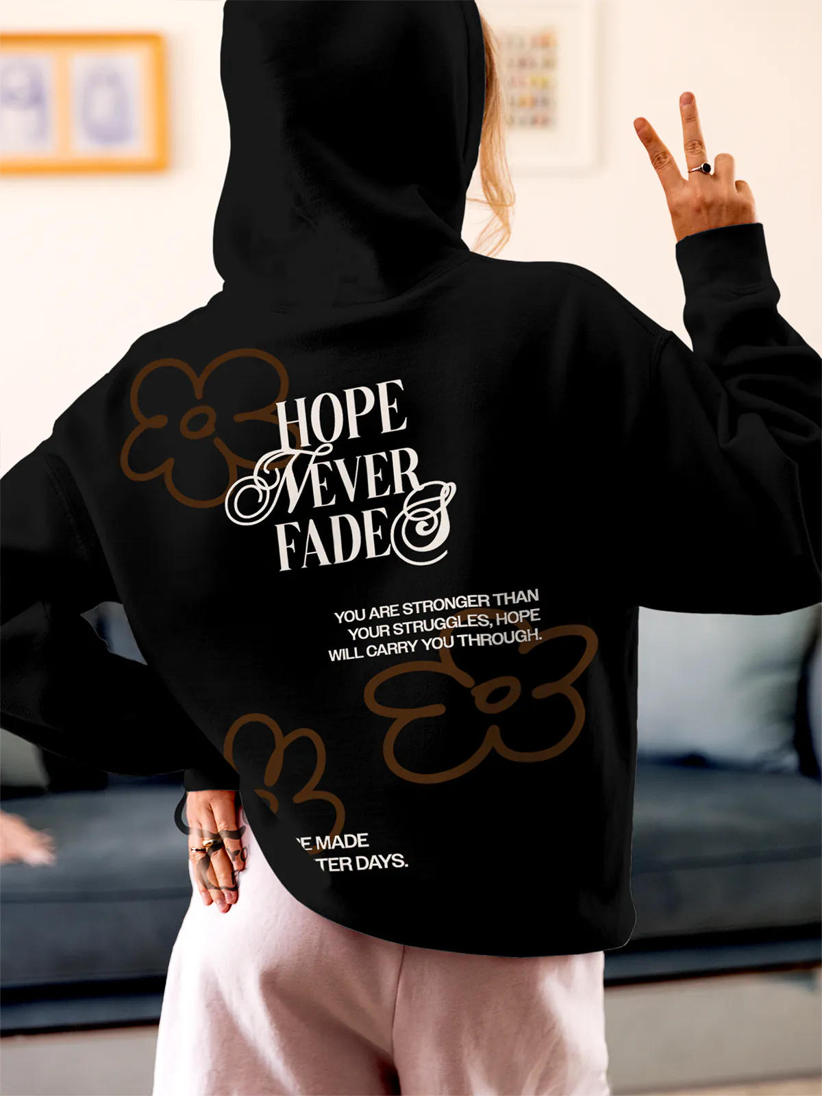 Model wearing Women's Black Hoodie Sweatshirt with 'Hope Never Fades' design, offering effortless style and premium comfort