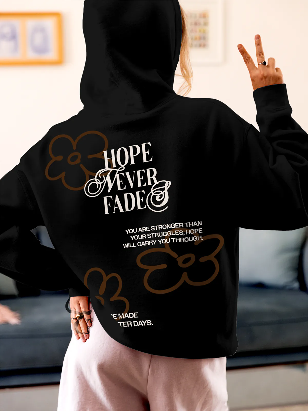 Model wearing Women's Black Hoodie Sweatshirt with 'Hope Never Fades' design, offering effortless style and premium comfort