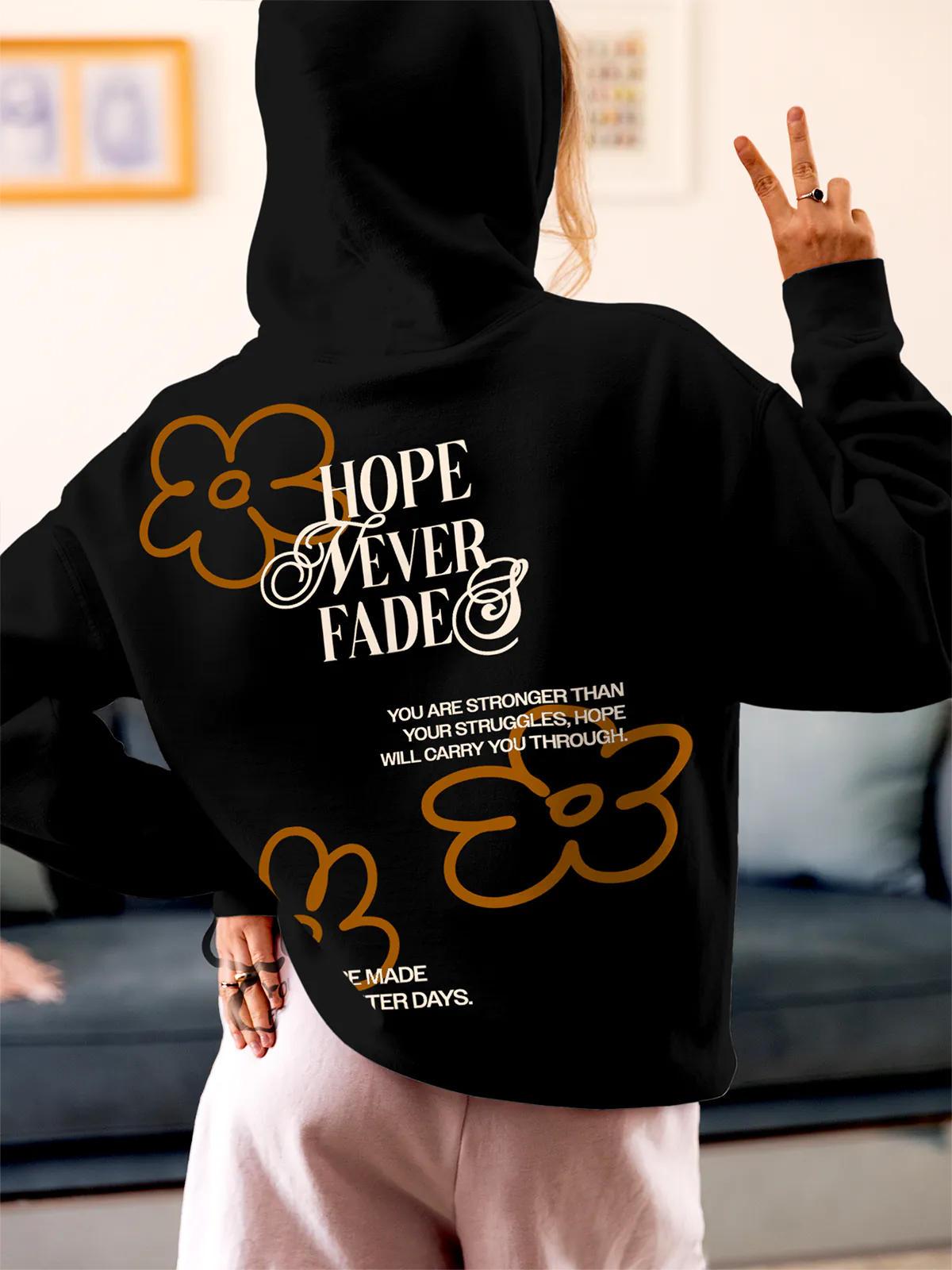 Model wearing Women's Black Hoodie Sweatshirt with 'Hope Never Fades' design, offering effortless style and premium comfort