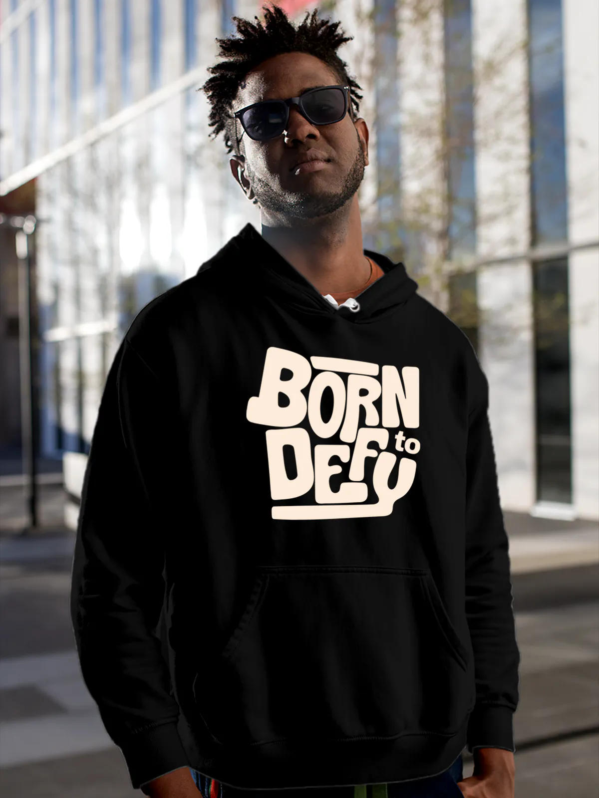 Model wearing Men's Black Hoodie Sweatshirt with 'Born To Defy' design, offering effortless style and premium comfort