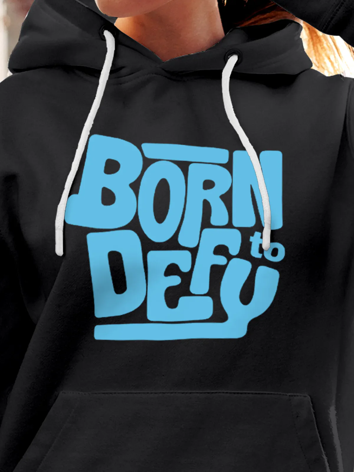 Close up of 'Born To Defy' design on Women's Dark Grey Hoodie Sweatshirt, highlighting intricate details and vibrant print.