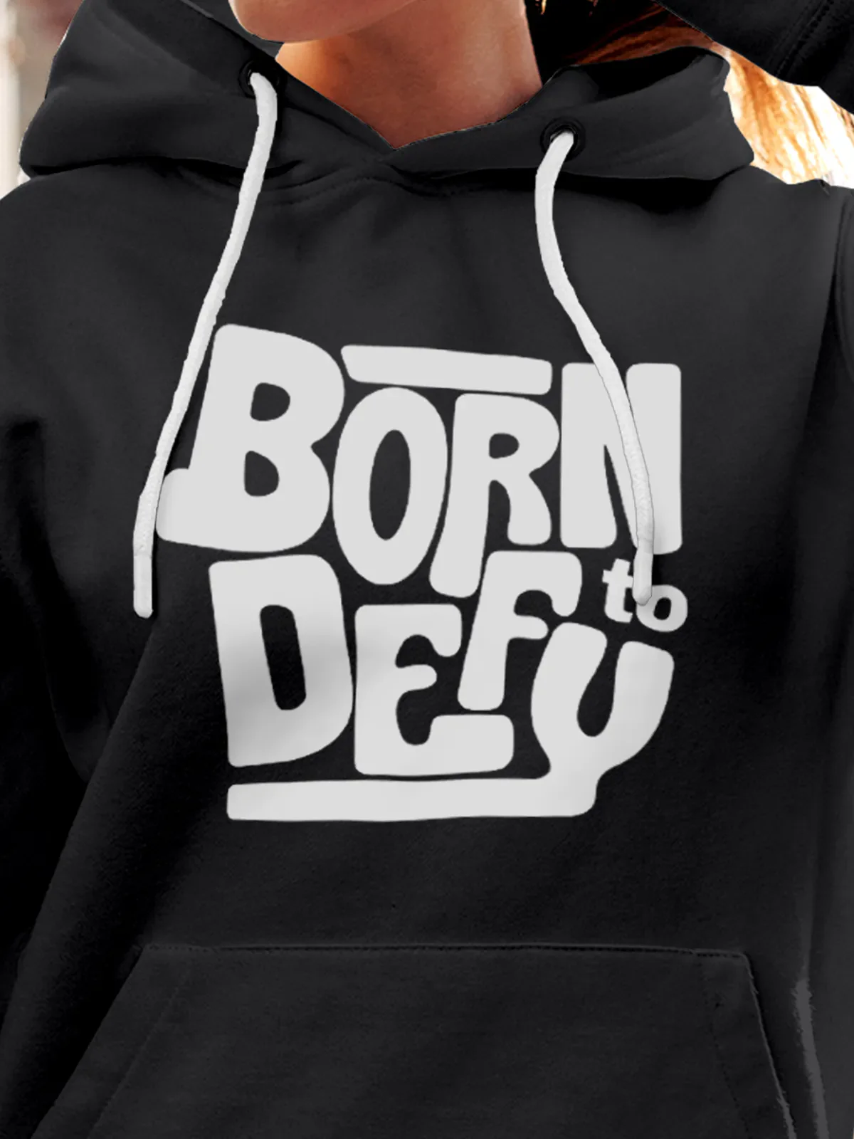 Close up of 'Born To Defy' design on Women's Dark Grey Hoodie Sweatshirt, highlighting intricate details and vibrant print.