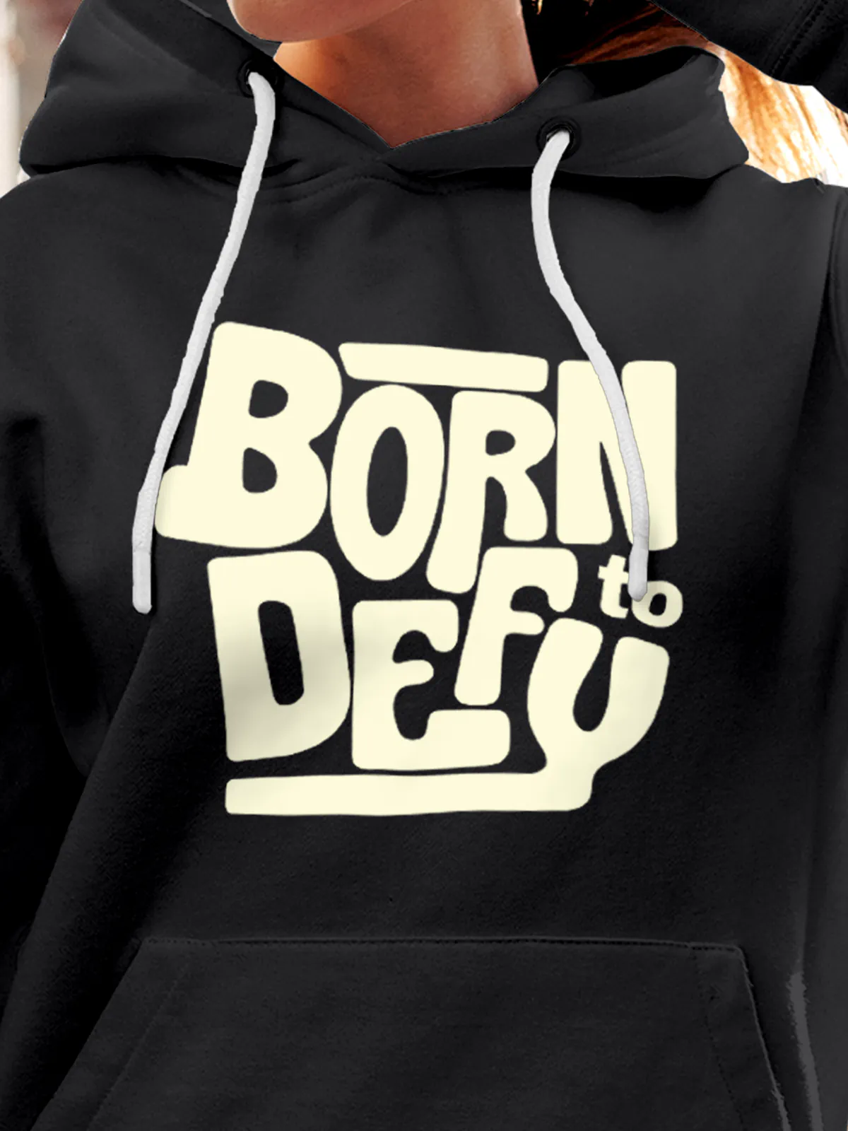 Close up of 'Born To Defy' design on Women's Dark Grey Hoodie Sweatshirt, highlighting intricate details and vibrant print.