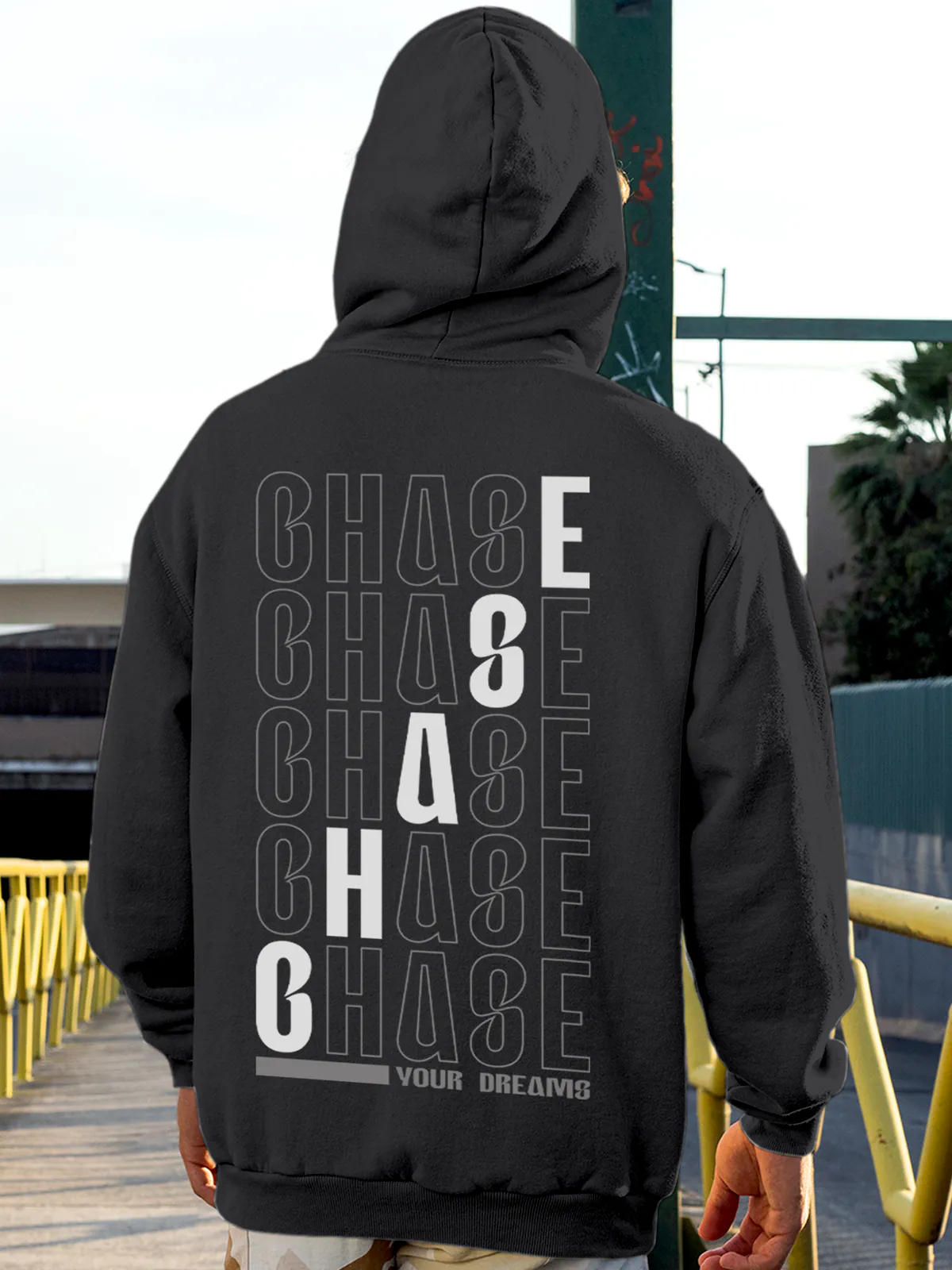 Model wearing Men's Dark Grey Hoodie Sweatshirt with 'Chase Your Dreams' design, offering effortless style and premium comfort