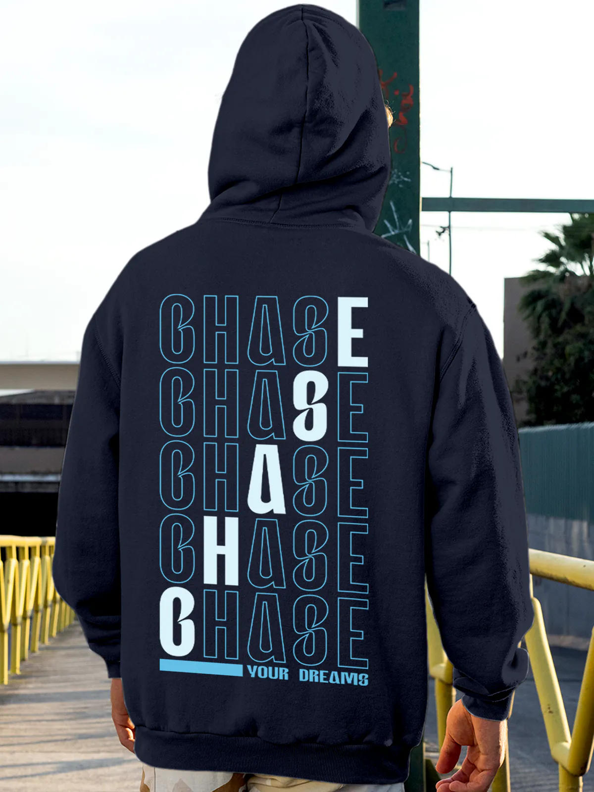 Model wearing Men's Navy Blue Hoodie Sweatshirt with 'Chase Your Dreams' design, offering effortless style and premium comfort