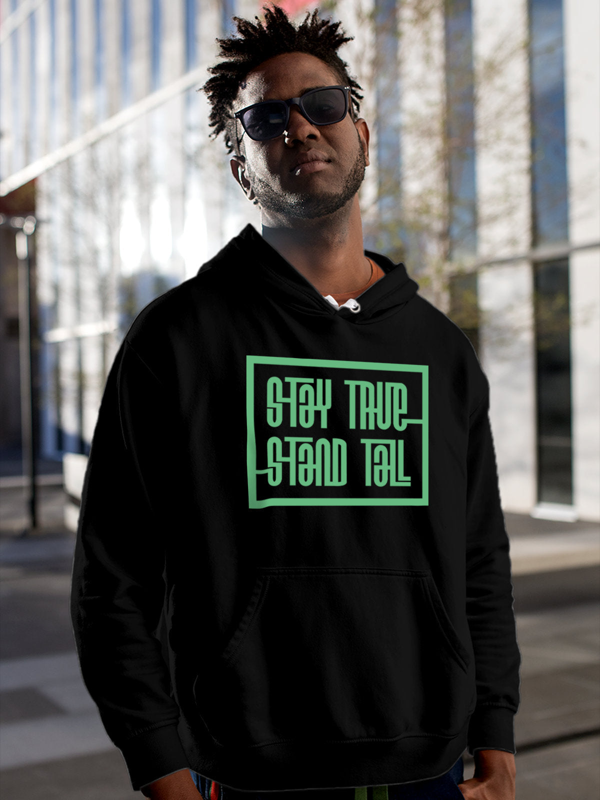 Model wearing Men's Black Hoodie Sweatshirt with 'Stay True Stand Tall' design, offering effortless style and premium comfort