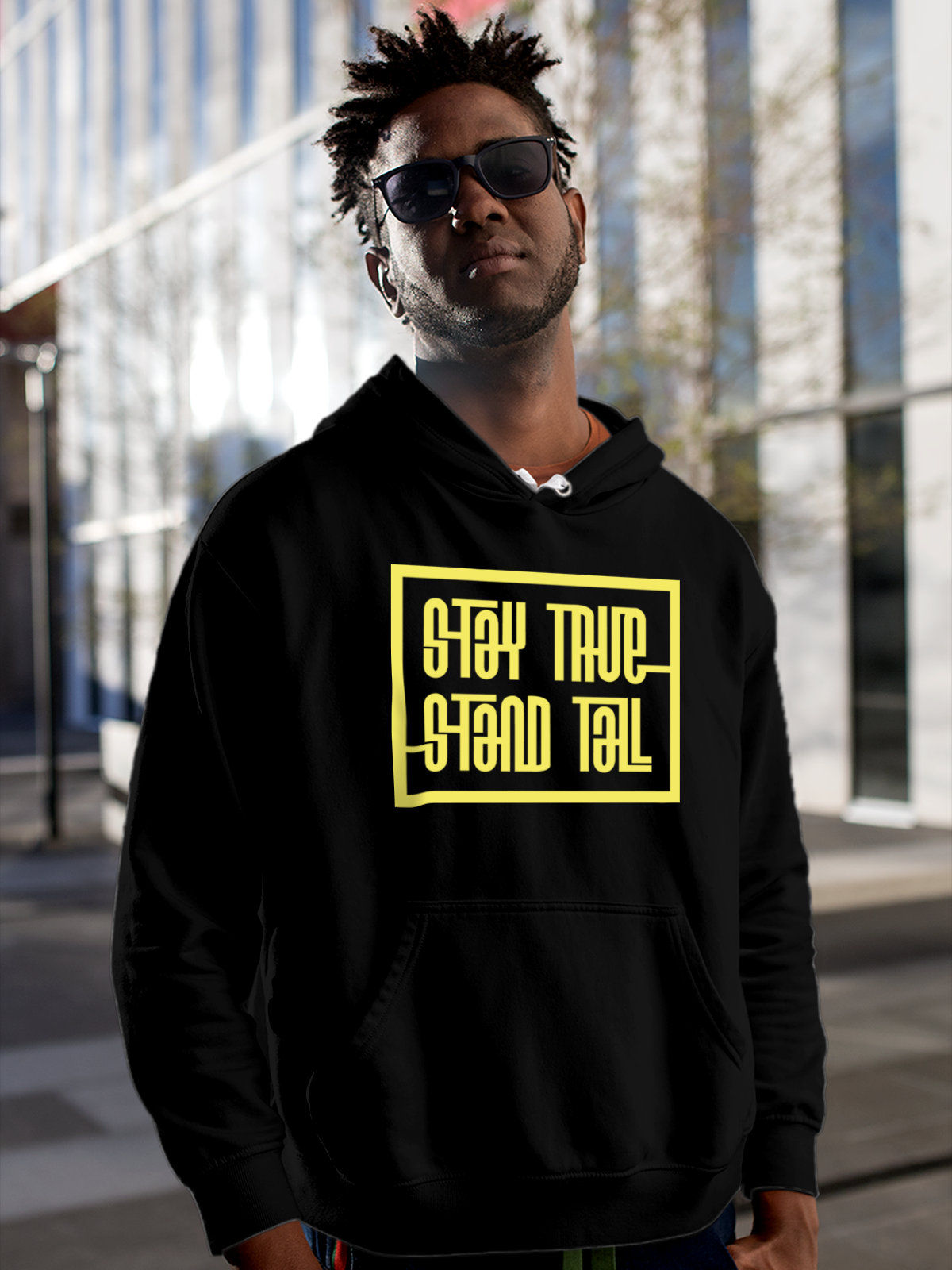 Model wearing Men's Black Hoodie Sweatshirt with 'Stay True Stand Tall' design, offering effortless style and premium comfort