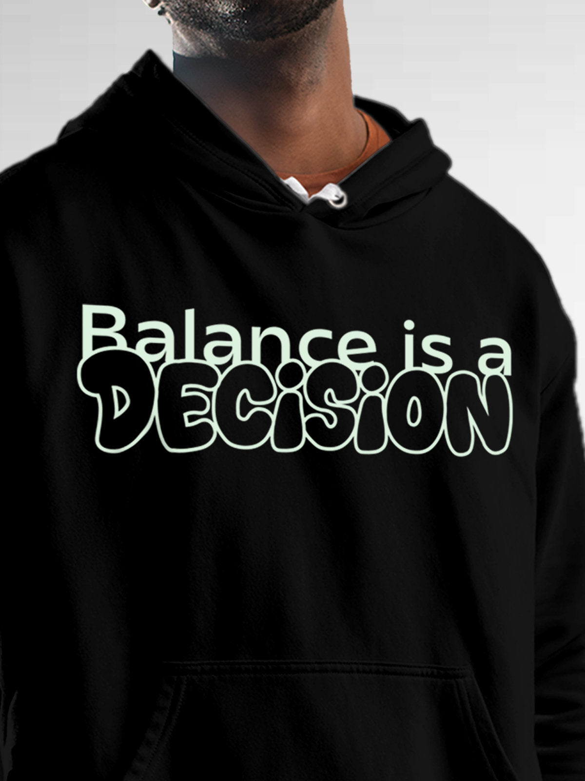 Close up of 'Balance Is A Decision' design on Men's Black Hoodie Sweatshirt, highlighting intricate details and vibrant print.