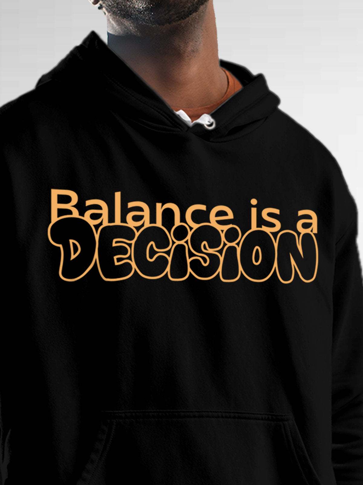 Close up of 'Balance Is A Decision' design on Men's Black Hoodie Sweatshirt, highlighting intricate details and vibrant print.