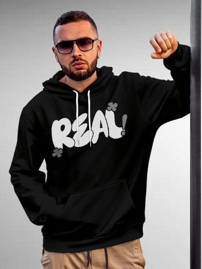 Model wearing Men's Black Hoodie Sweatshirt with 'Real' design, offering effortless style and premium comfort