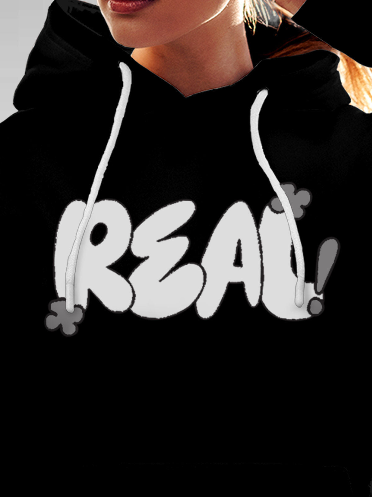 Close up of 'Real' design on Women's Black Hoodie Sweatshirt, highlighting intricate details and vibrant print.