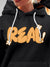 Close up of 'Real' design on Women's Dark Grey Hoodie Sweatshirt, highlighting intricate details and vibrant print.