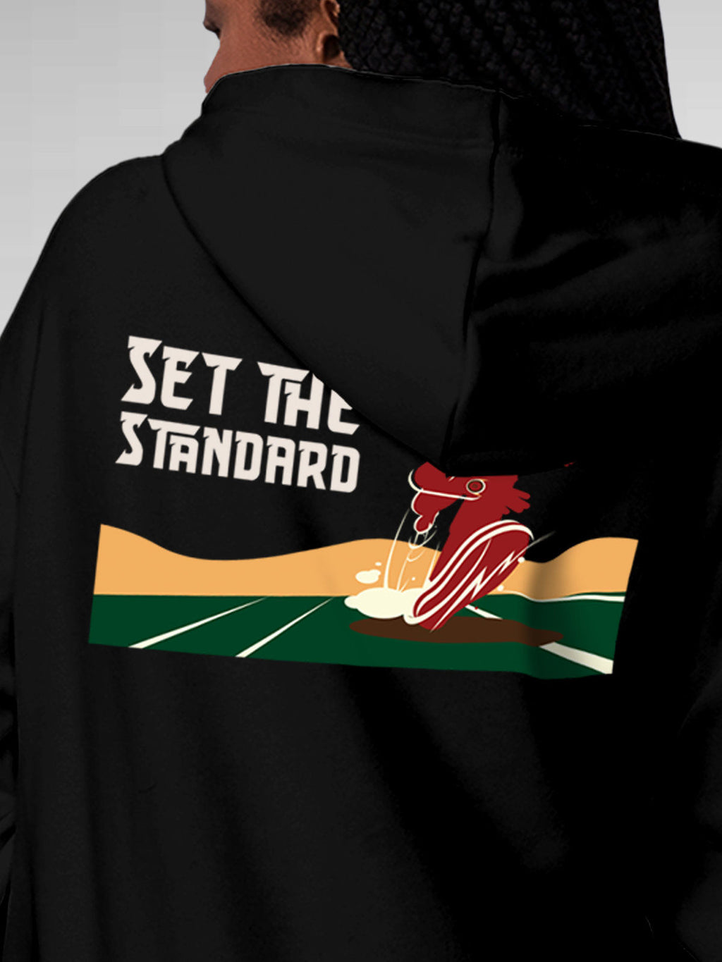 Close up of 'Raise The Bar' design on Women's Black Hoodie Sweatshirt, highlighting intricate details and vibrant print.