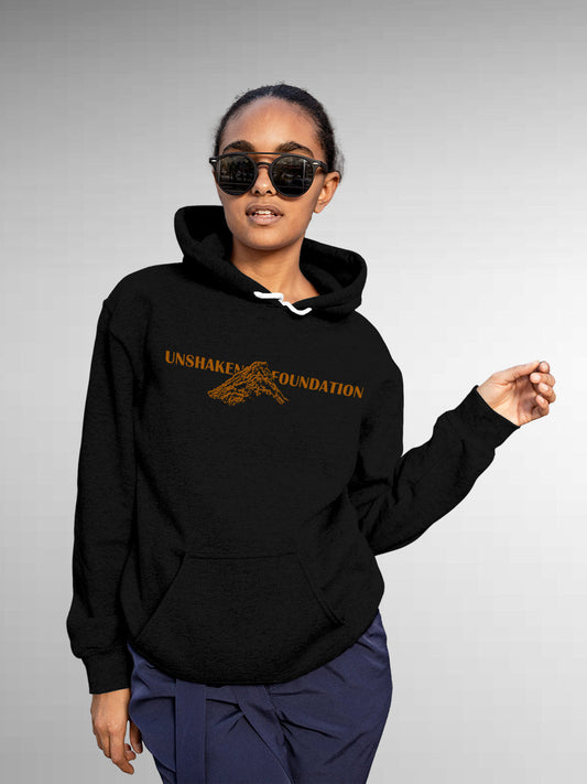 Model wearing Women's Black Hoodie Sweatshirt with 'Unshaken Foundation' design, offering effortless style and premium comfort