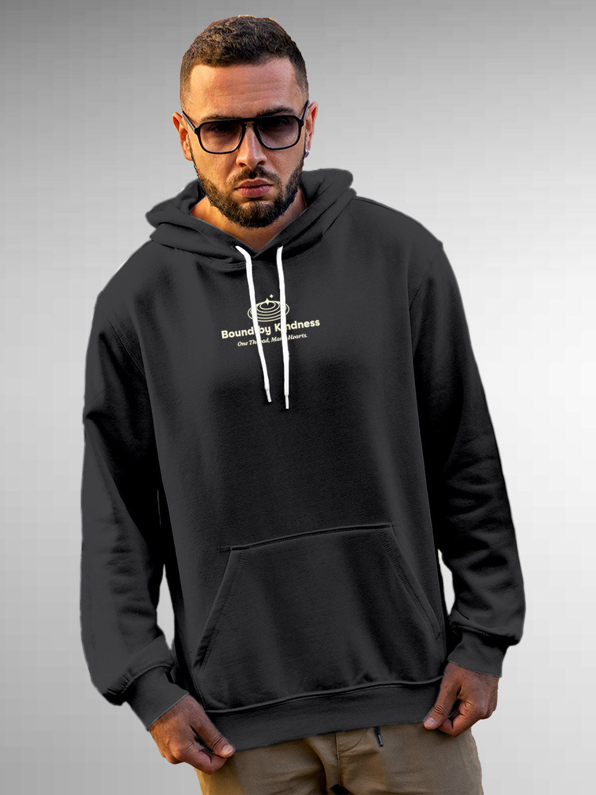 Model wearing Men's Dark Grey Hoodie Sweatshirt with 'Bound By Kindness' design, offering effortless style and premium comfort