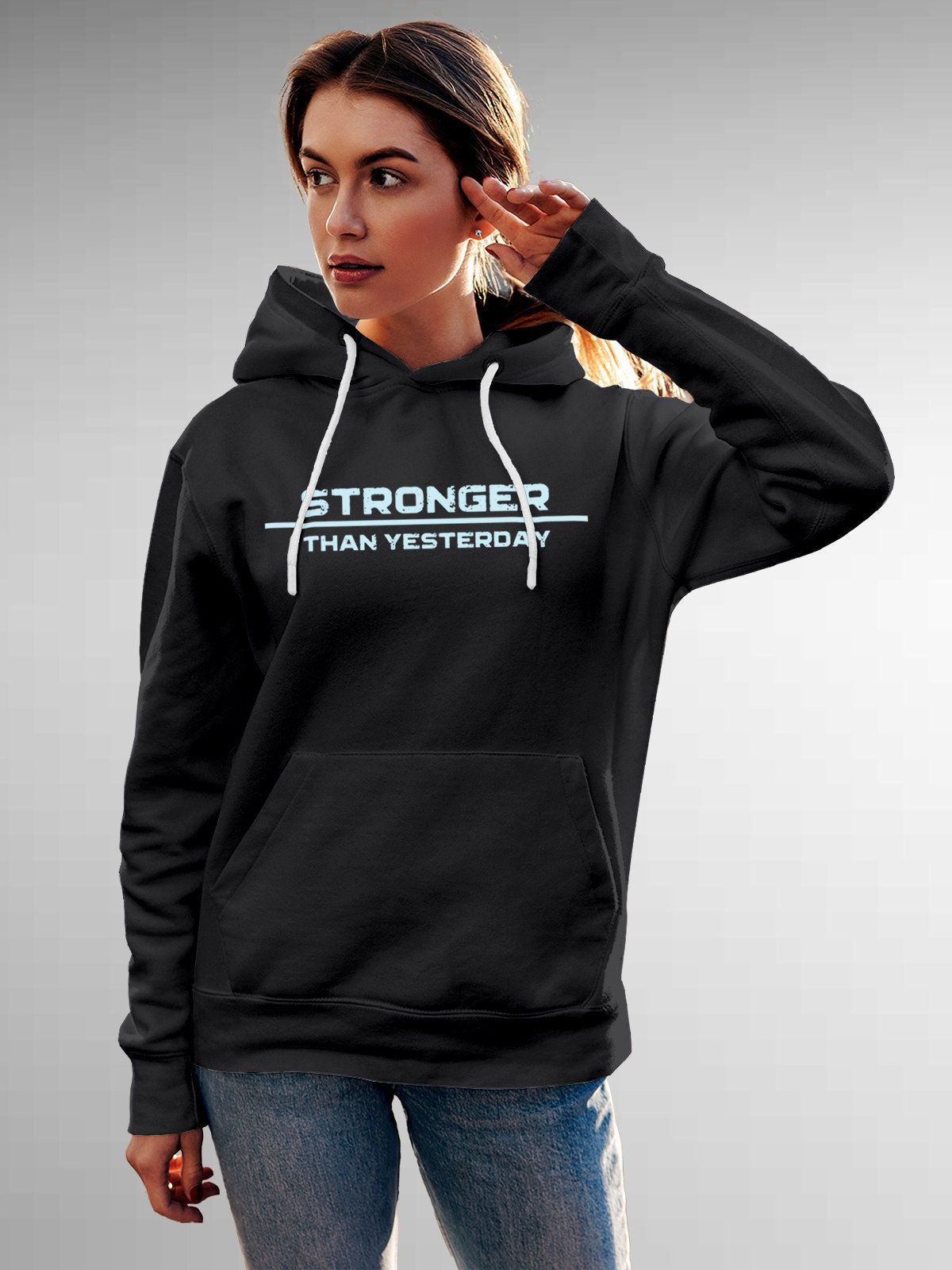 Model wearing Women's Dark Grey Hoodie Sweatshirt with 'Stronger Than Yesterday' design, offering effortless style and premium comfort