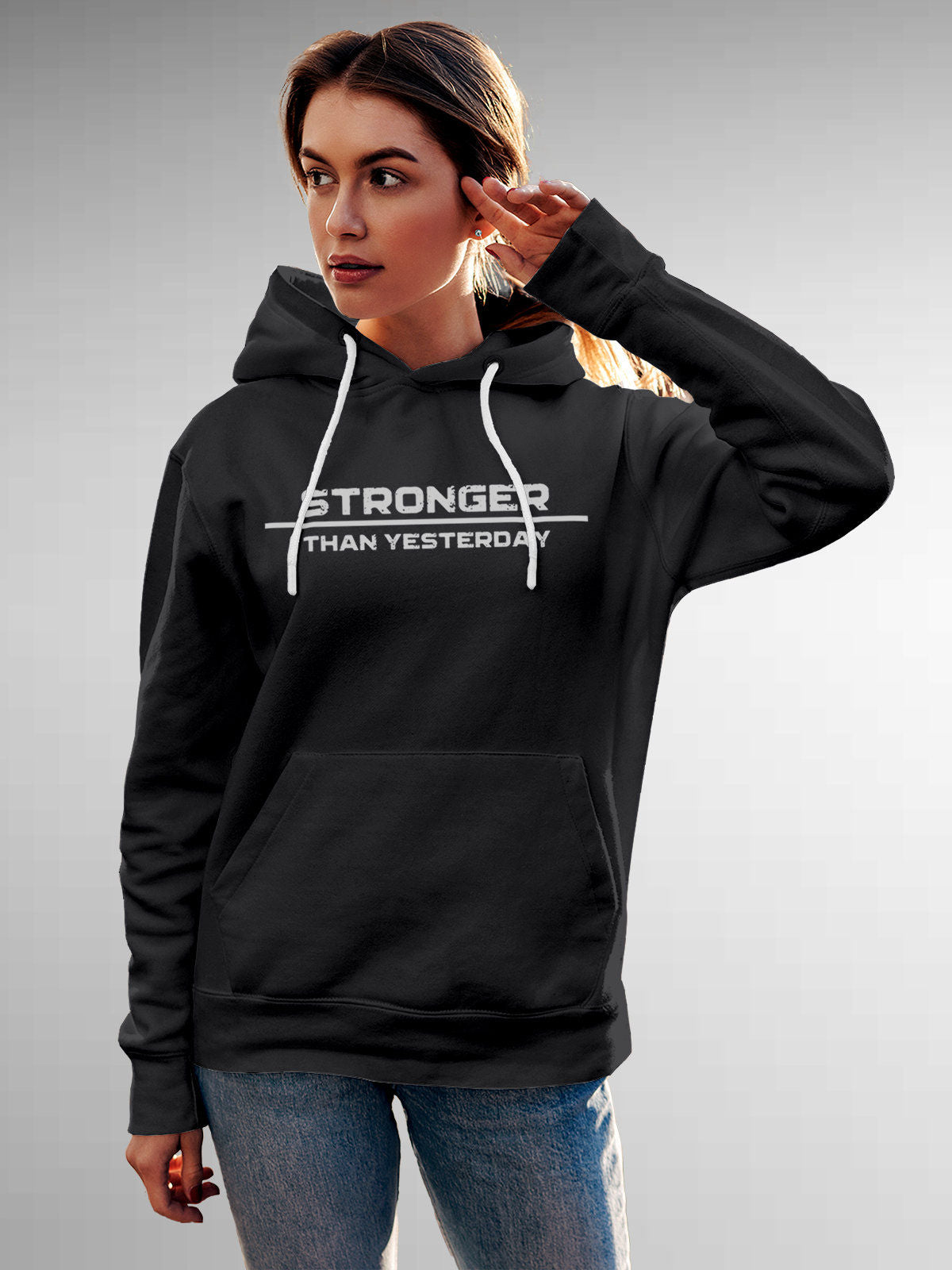 Model wearing Women's Dark Grey Hoodie Sweatshirt with 'Stronger Than Yesterday' design, offering effortless style and premium comfort