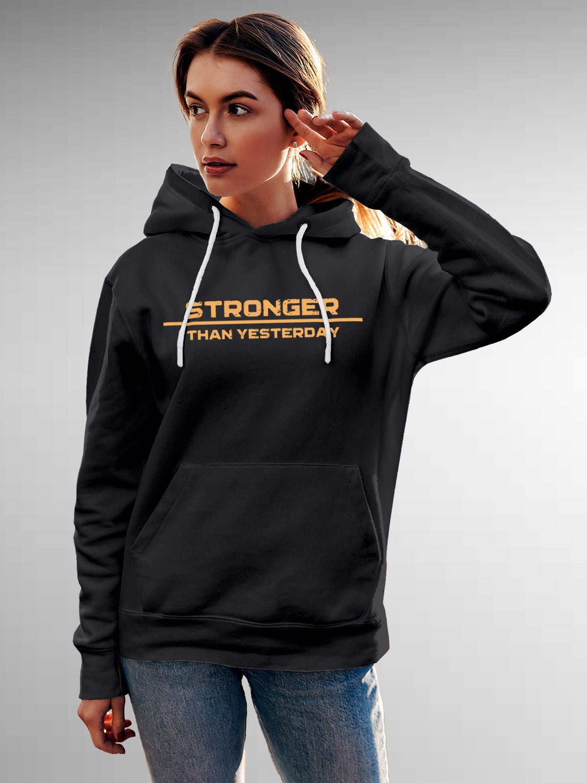 Model wearing Women's Dark Grey Hoodie Sweatshirt with 'Stronger Than Yesterday' design, offering effortless style and premium comfort