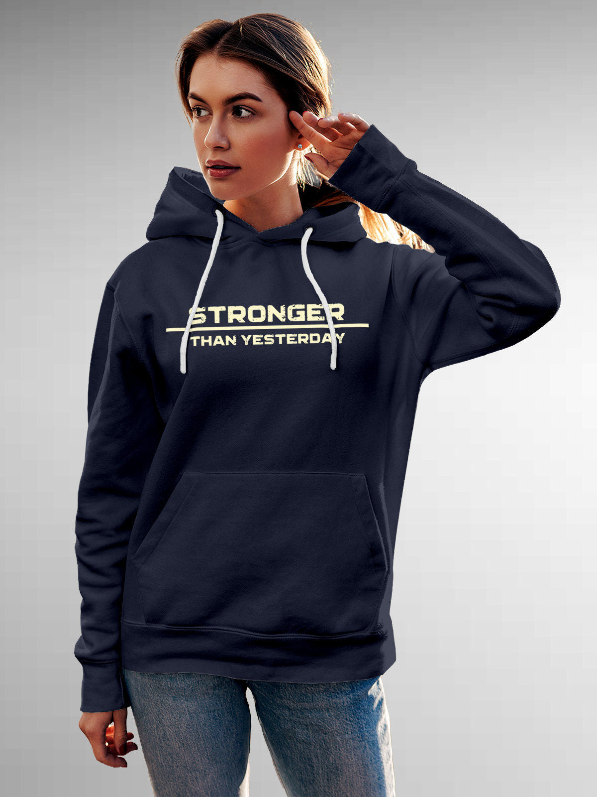 Model wearing Women's Navy Blue Hoodie Sweatshirt with 'Stronger Than Yesterday' design, offering effortless style and premium comfort