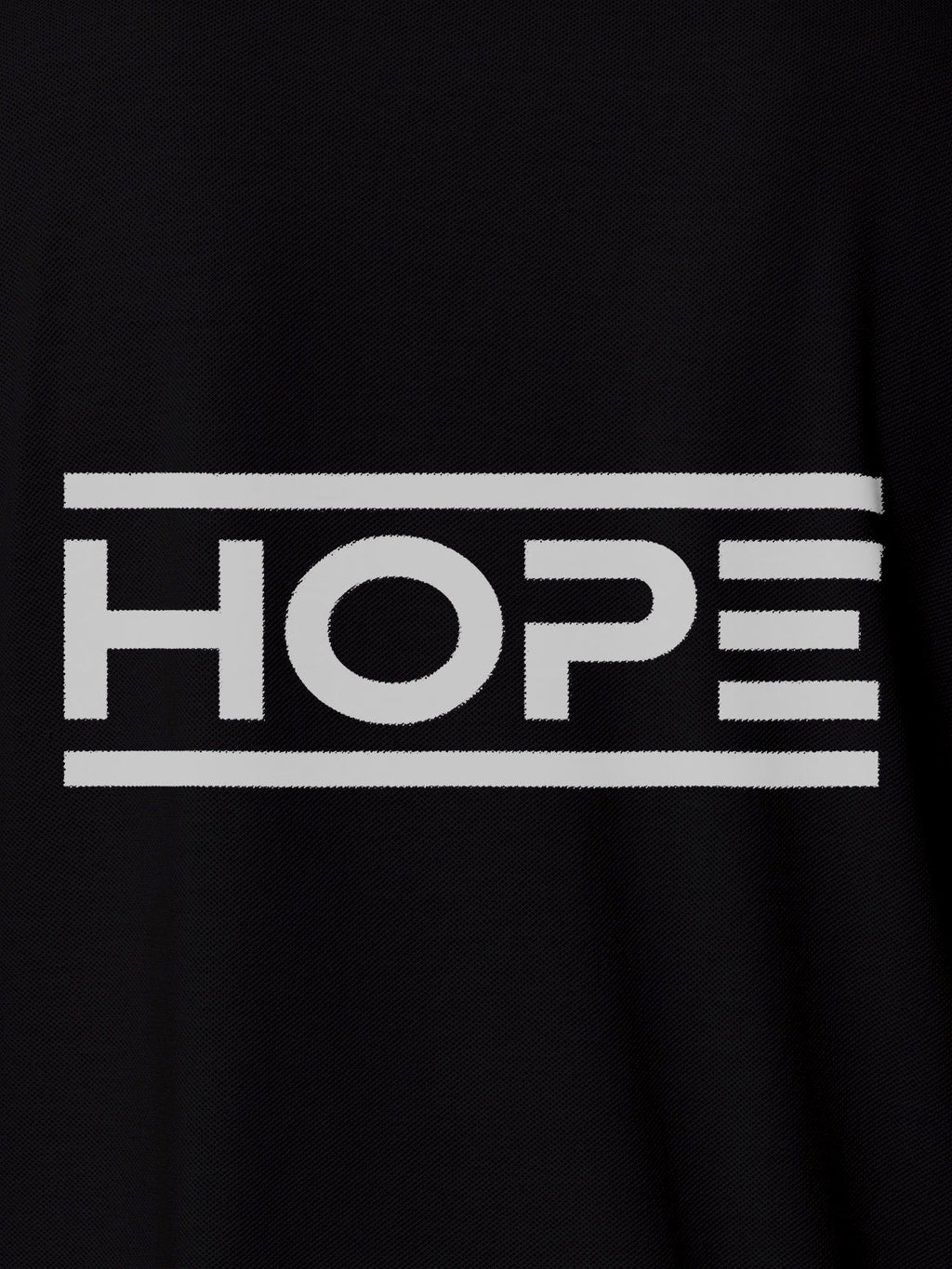 Close up of 'Hope' design on Women's Black Polo T-shirt, highlighting intricate details and vibrant print.