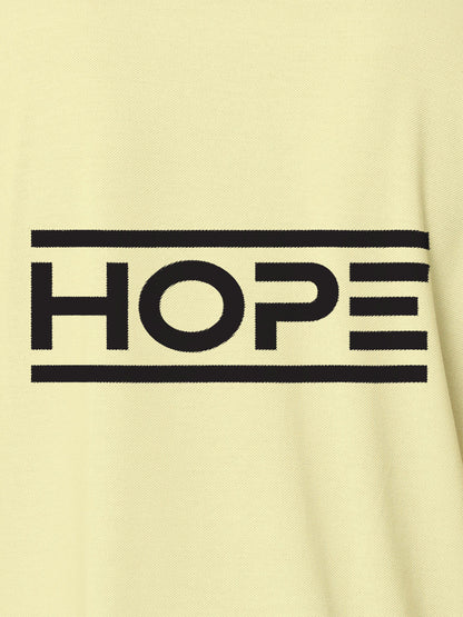 Close up of 'Hope' design on Women's Yellow Polo T-shirt, highlighting intricate details and vibrant print.
