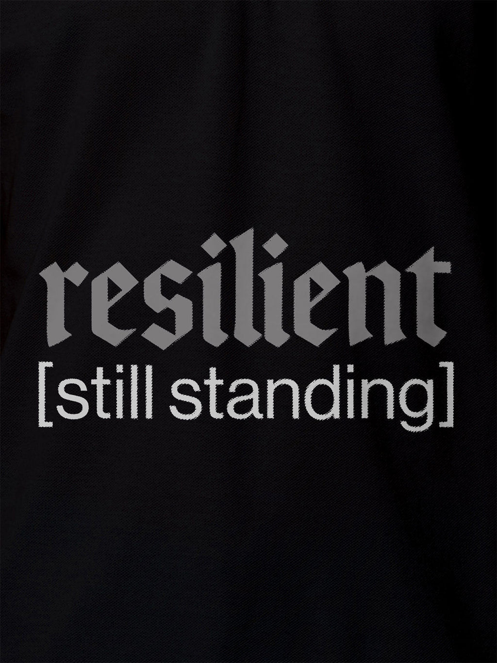 Close up of 'Resilient' design on Women's Black Polo T-shirt, highlighting intricate details and vibrant print.