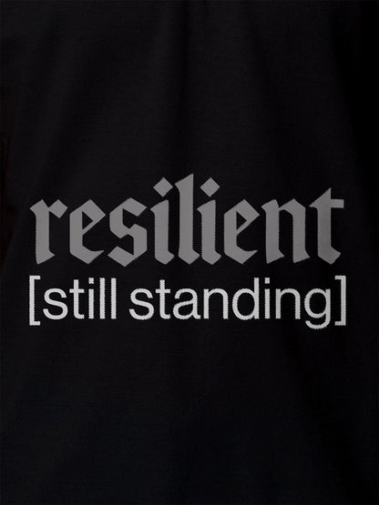 Close up of 'Resilient' design on Women's Black Polo T-shirt, highlighting intricate details and vibrant print.