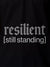 Close up of 'Resilient' design on Women's Black Polo T-shirt, highlighting intricate details and vibrant print.