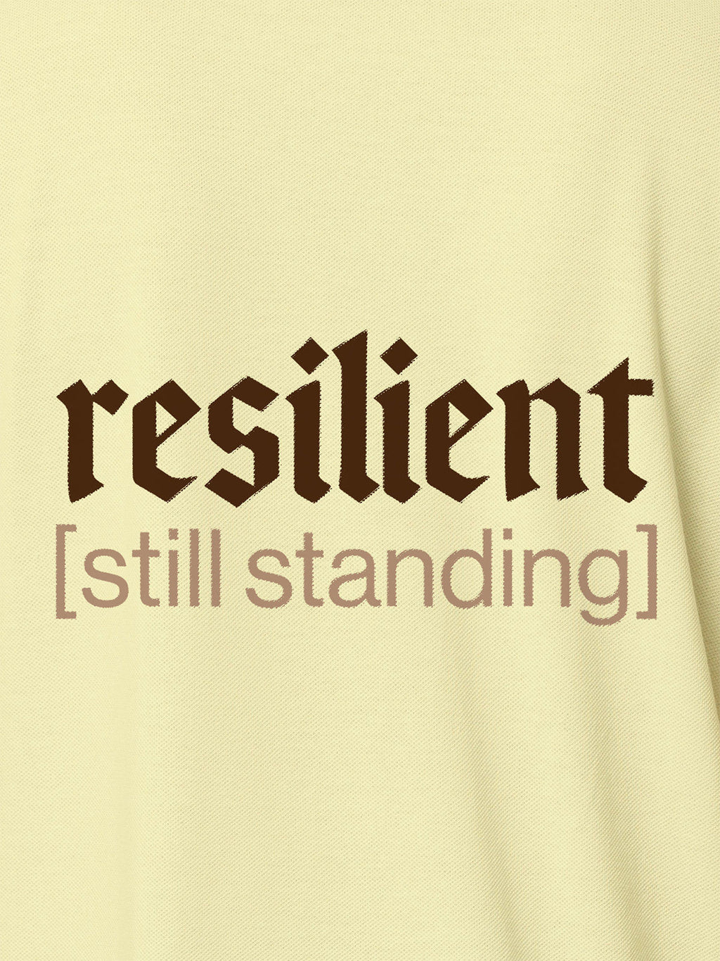 Close up of 'Resilient' design on Men's Yellow Polo T-shirt, highlighting intricate details and vibrant print.