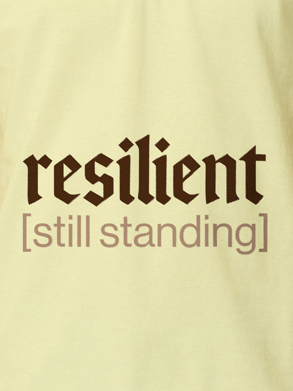 Close up of 'Resilient' design on Women's Yellow Polo T-shirt, highlighting intricate details and vibrant print.