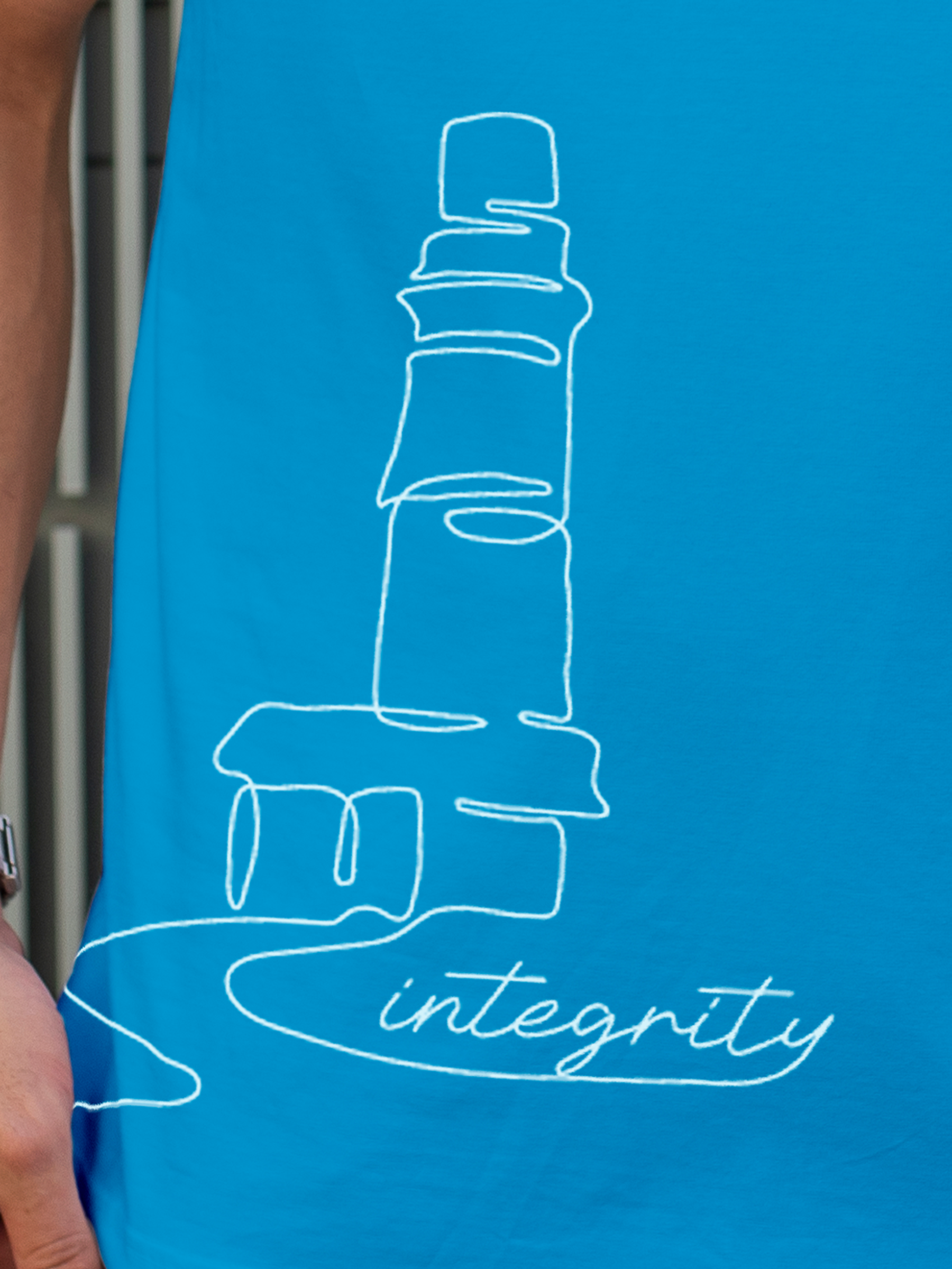 Close up of 'Integrity' design on Men's Blue Polo T-shirt, highlighting intricate details and vibrant print.