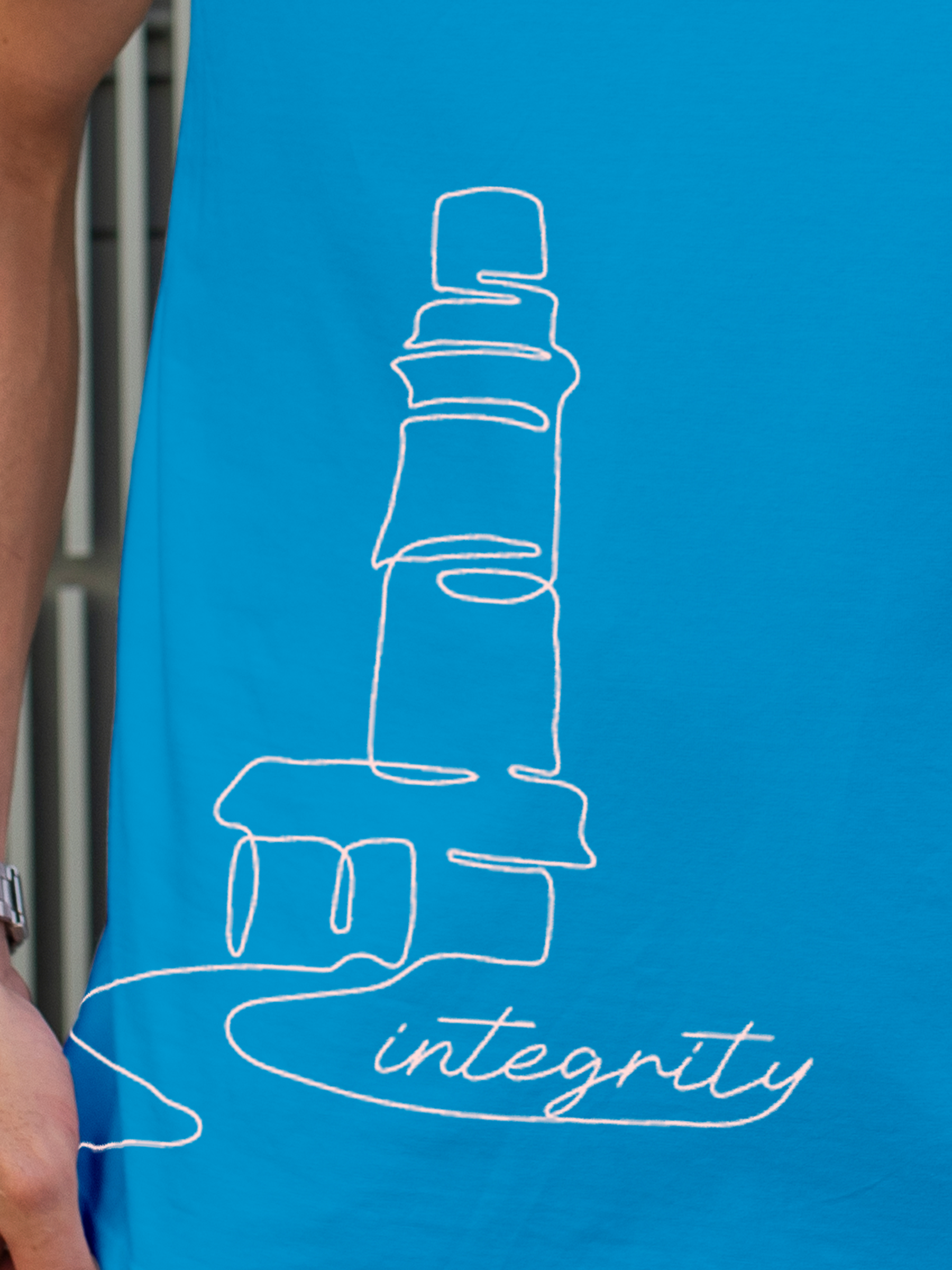 Close up of 'Integrity' design on Men's Blue Polo T-shirt, highlighting intricate details and vibrant print.