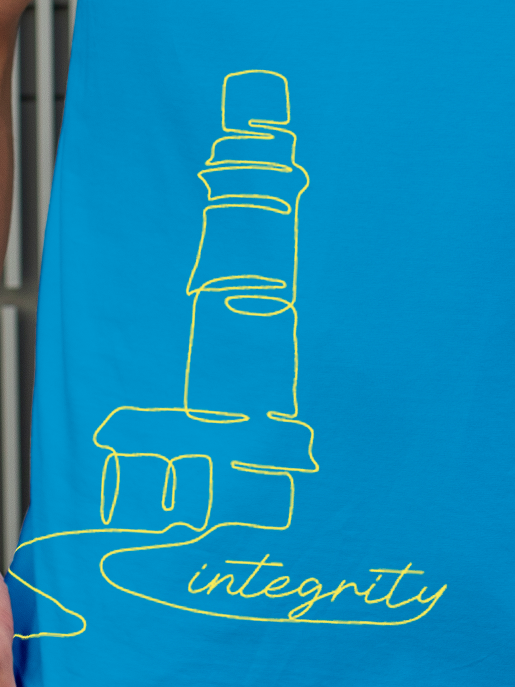 Close up of 'Integrity' design on Men's Blue Polo T-shirt, highlighting intricate details and vibrant print.
