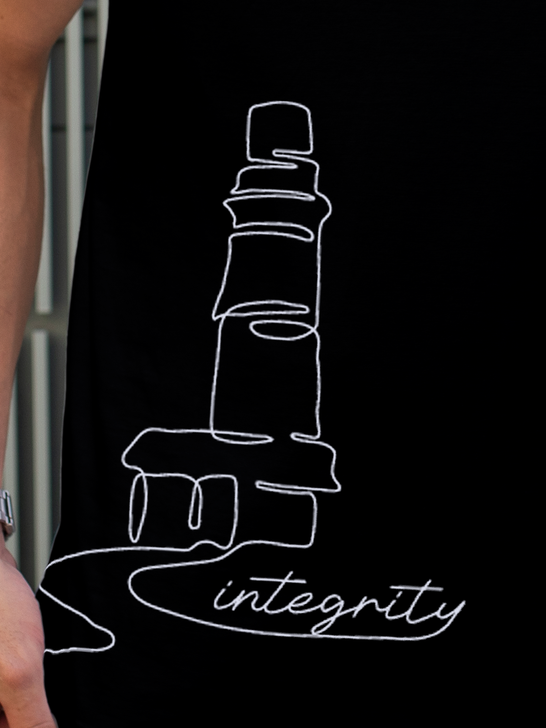 Close up of 'Integrity' design on Men's Black Polo T-shirt, highlighting intricate details and vibrant print.