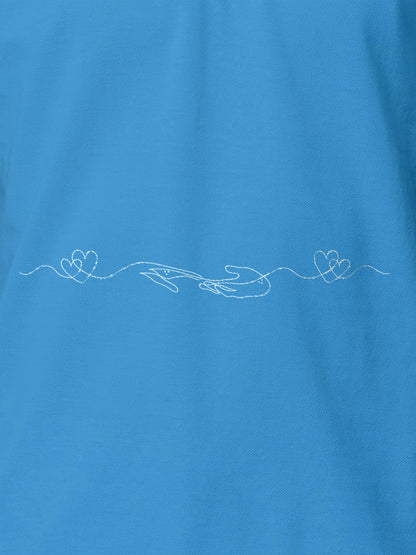 Close up of 'Empathy' design on Women's Blue Polo T-shirt, highlighting intricate details and vibrant print.