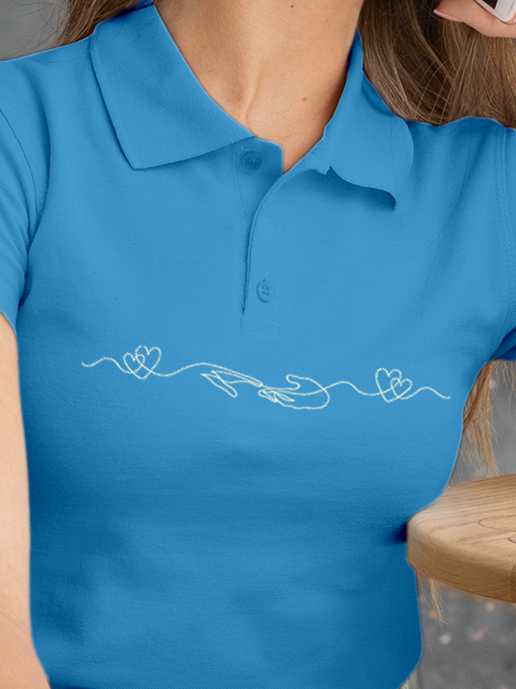 Close up of 'Empathy' design on Women's Blue Polo T-shirt, highlighting intricate details and vibrant print.