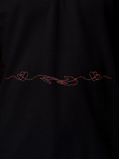Close up of 'Empathy' design on Women's Black Polo T-shirt, highlighting intricate details and vibrant print.
