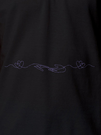 Close up of 'Empathy' design on Women's Dark Grey Polo T-shirt, highlighting intricate details and vibrant print.