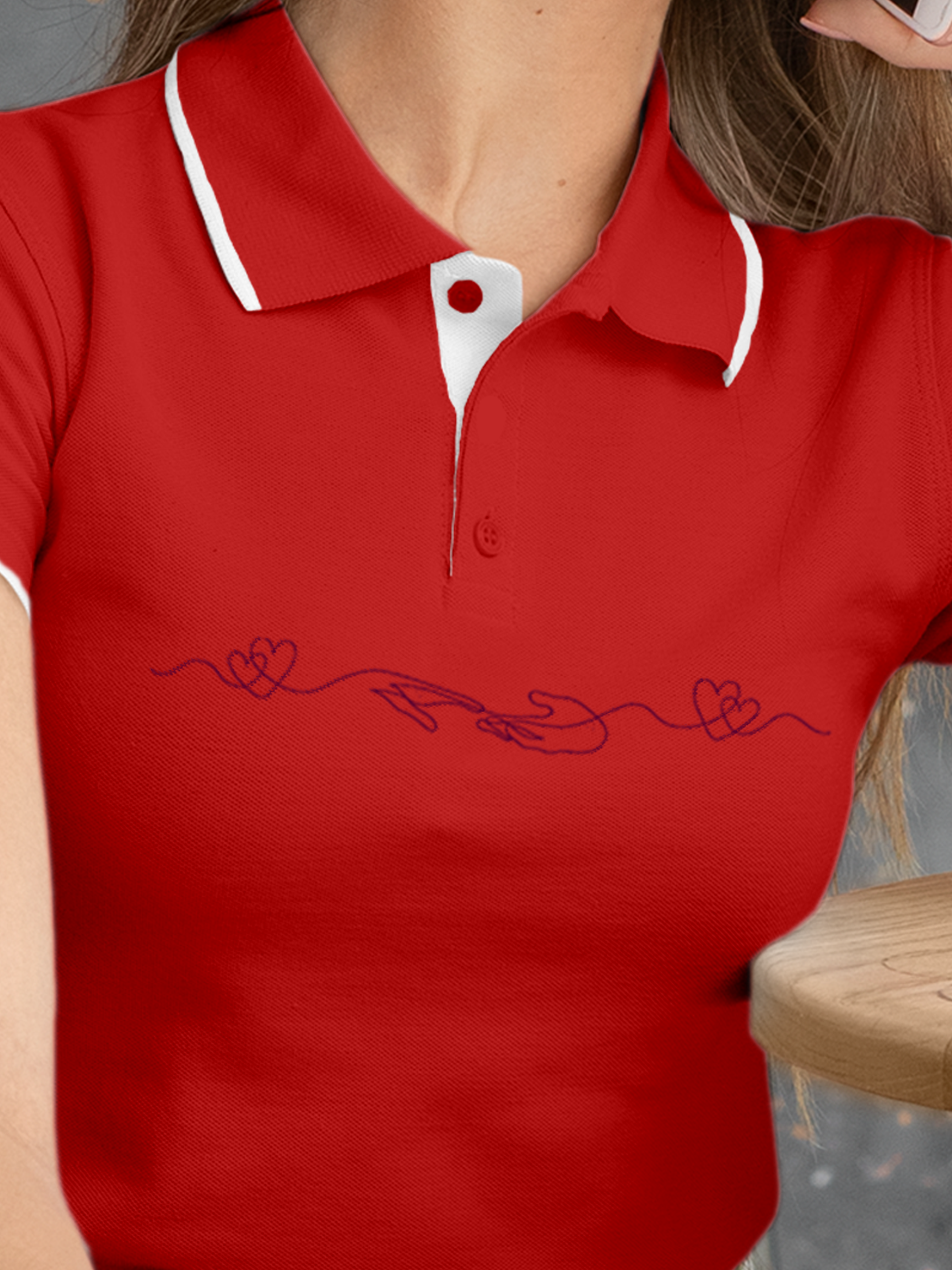 Close up of 'Empathy' design on Women's Red Polo T-shirt, highlighting intricate details and vibrant print.