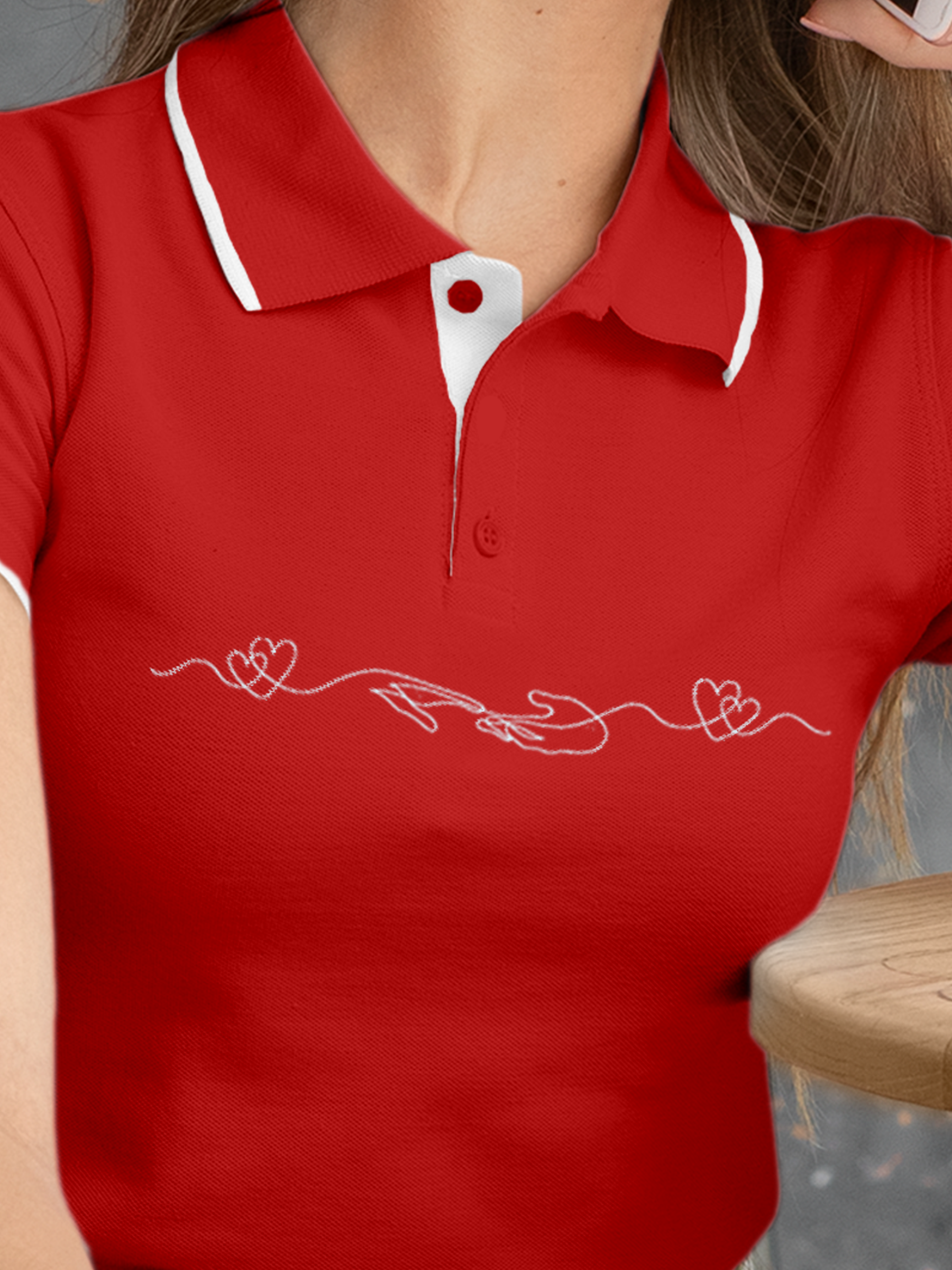Close up of 'Empathy' design on Women's Red Polo T-shirt, highlighting intricate details and vibrant print.