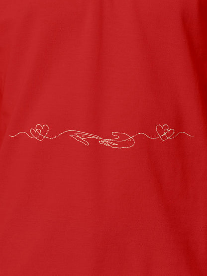 Close up of 'Empathy' design on Women's Red Polo T-shirt, highlighting intricate details and vibrant print.