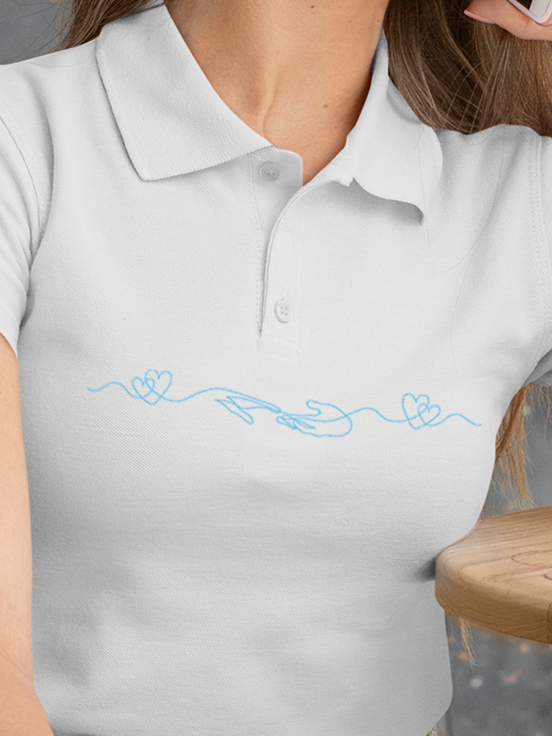 Close up of 'Empathy' design on Women's White Polo T-shirt, highlighting intricate details and vibrant print.