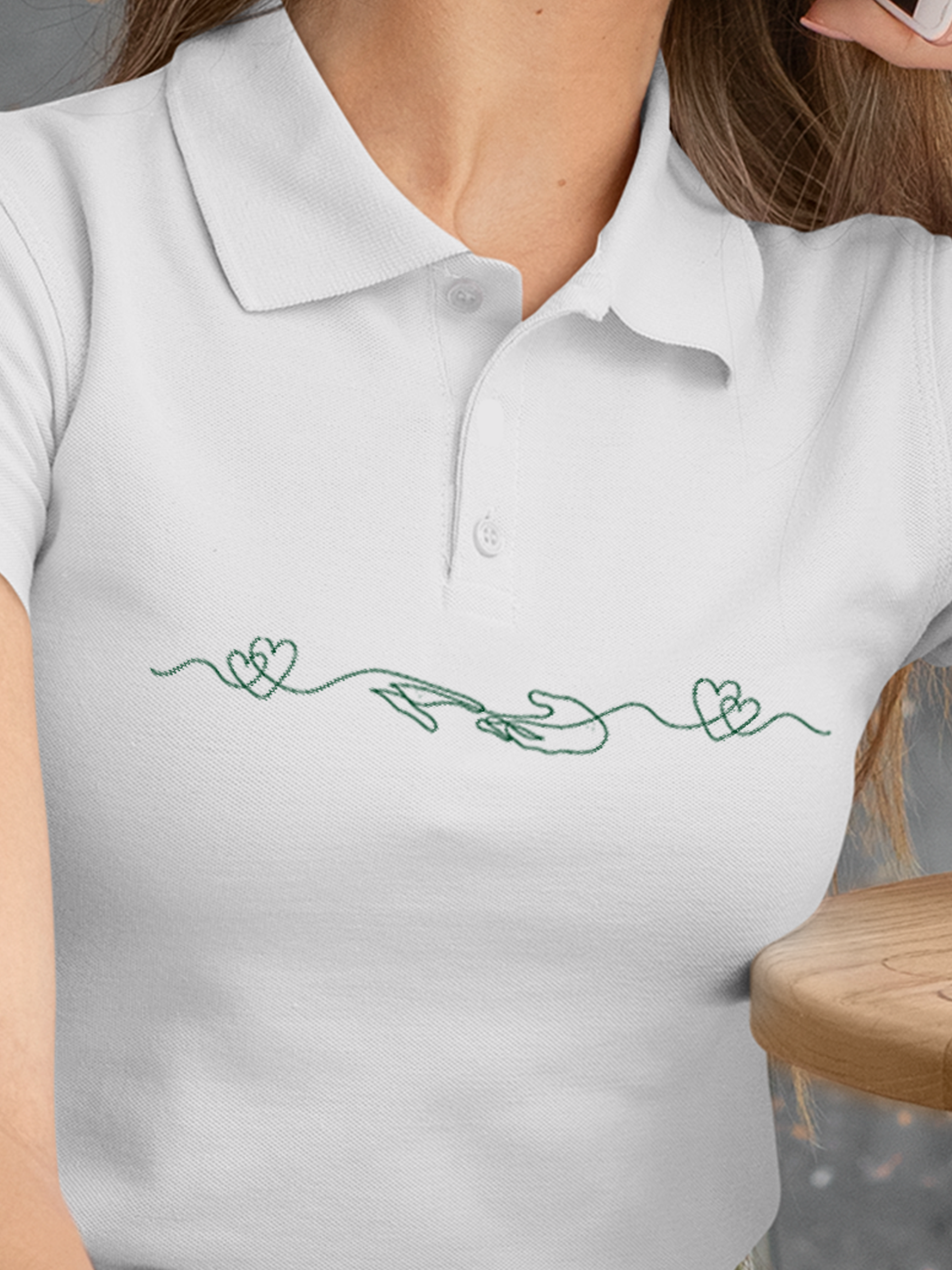 Close up of 'Empathy' design on Women's White Polo T-shirt, highlighting intricate details and vibrant print.