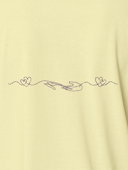 Close up of 'Empathy' design on Men's Yellow Polo T-shirt, highlighting intricate details and vibrant print.