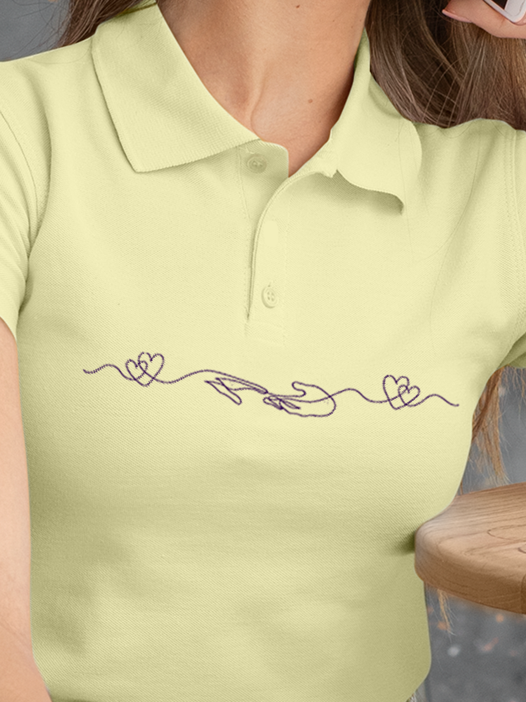 Close up of 'Empathy' design on Women's Yellow Polo T-shirt, highlighting intricate details and vibrant print.