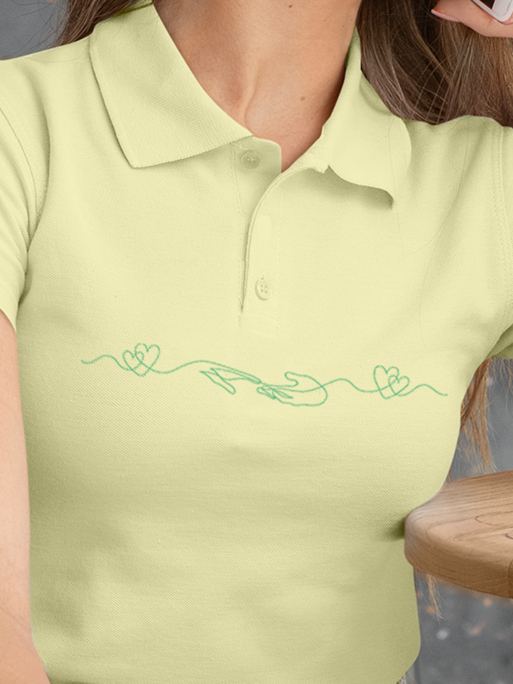 Close up of 'Empathy' design on Women's Yellow Polo T-shirt, highlighting intricate details and vibrant print.