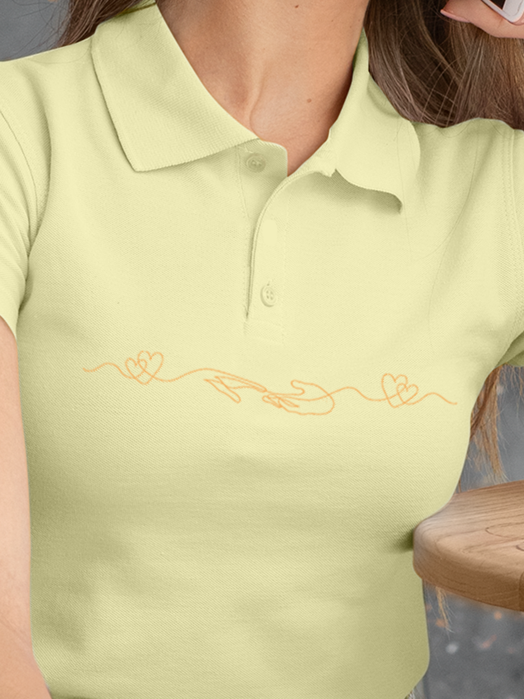 Close up of 'Empathy' design on Women's Yellow Polo T-shirt, highlighting intricate details and vibrant print.