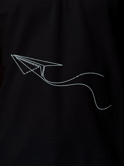 Close up of 'Empowered' design on Women's Black Polo T-shirt, highlighting intricate details and vibrant print.