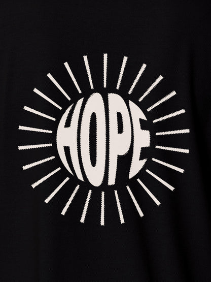 Close up of 'Hope' design on Women's Black Polo T-shirt, highlighting intricate details and vibrant print.