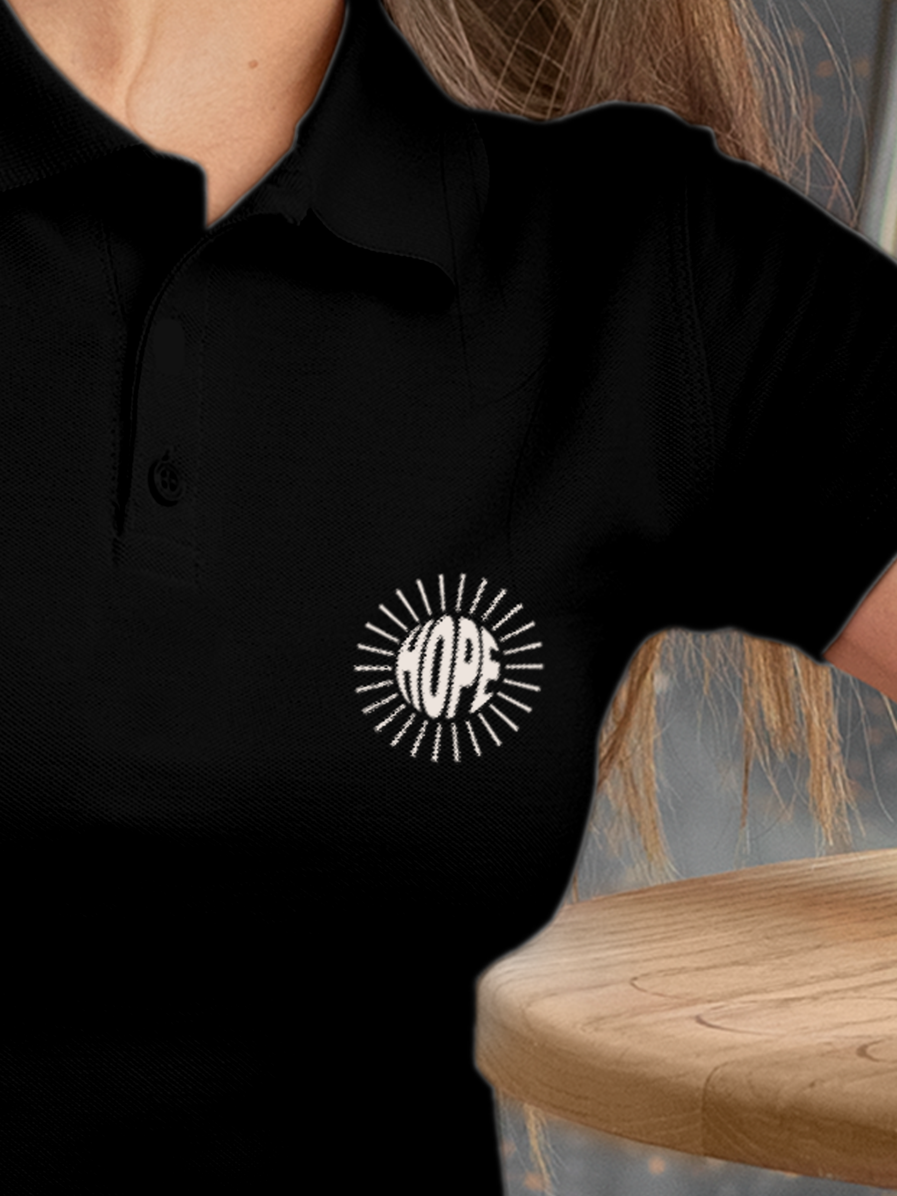 Close up of 'Hope' design on Women's Black Polo T-shirt, highlighting intricate details and vibrant print.